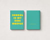 Two teal hardcover notebooks or journals displayed side by side on a light textured background. The left notebook shows the front cover with the text 'SCHOOL IS MY SIDE HUSTLE' printed in bold yellow letters.