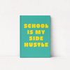 A teal hardcover notebook with bold yellow text reading 'SCHOOL IS MY SIDE HUSTLE' on a clean white background.