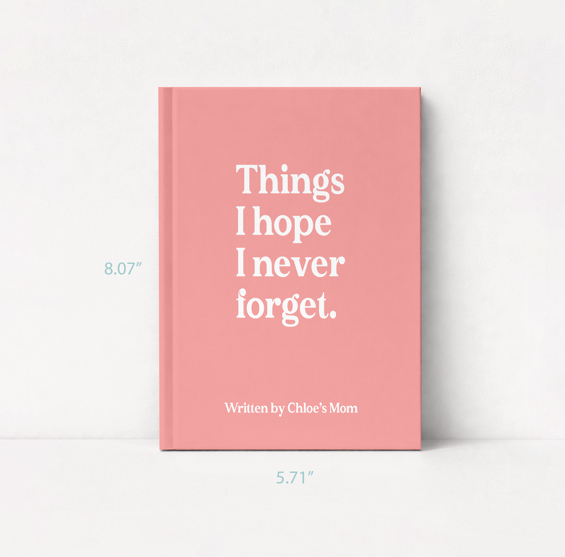 A pink hardcover book standing upright against a white background, with white text on the cover reading 'Things I hope I never forget.' and smaller text 'Written by Chloe's Mom.