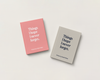 Two hardcover books titled "Things I hope I never forget." by authors Daniel's Mom, one in pink and one in light gray, displayed on a clean off-white background.