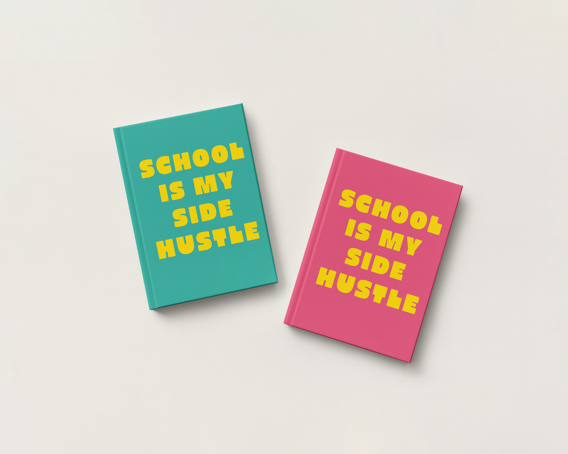Two hardcover books with the phrase 'SCHOOL IS MY SIDE HUSTLE' printed in yellow on the covers, one in teal and one in pink, arranged on a light beige background.