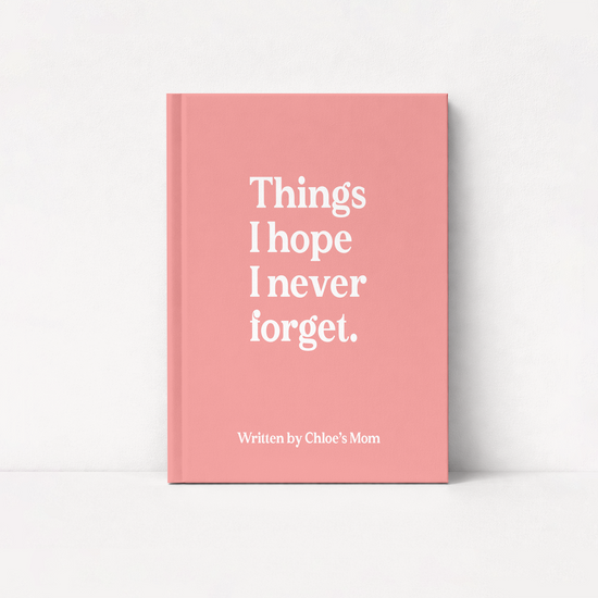 A pink hardcover book standing upright against a white background, with the title 'Things I hope I never forget.' in large white serif text and the subtitle 'Written by Chloe's Mom' near the bottom.