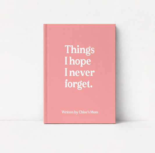 A pink hardcover book standing upright against a white background, with the title 'Things I hope I never forget.' in large white serif text and the subtitle 'Written by Chloe's Mom' near the bottom.