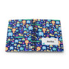 A personalized spiral-bound notebook with a colorful cartoon pattern of animals, rainbows, and stars on a dark blue background. The cover has a white label with the name 'Jordan' printed on it.