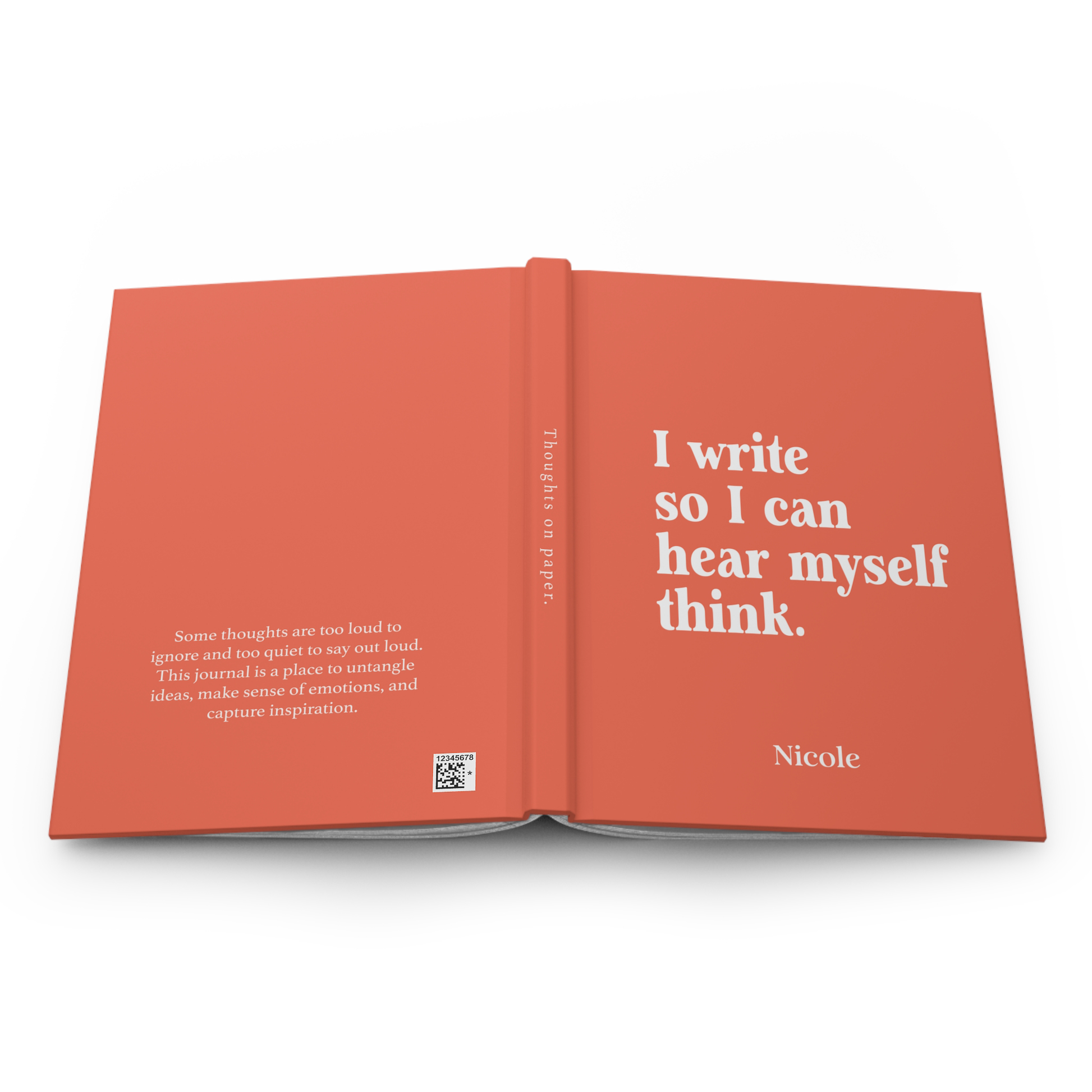 An open hardcover journal or book with a coral-orange cover and white text, photographed on a clean white background. The right page reads, 'I write so I can hear myself think.