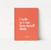 A coral orange hardcover book with white text reading 'I write so I can hear myself think.' and the name 'Nicole' at the bottom, shown standing against a white wall.