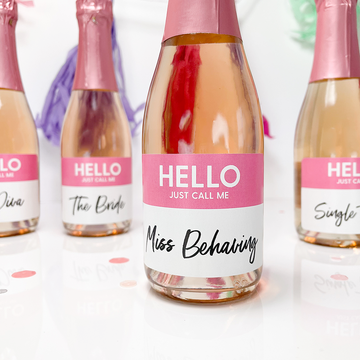 bachelorette party name labels on mini bottles of wine and champagen