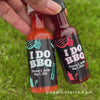 i do bbq miniature bottles of hot sauce and barbeque sauce in hand