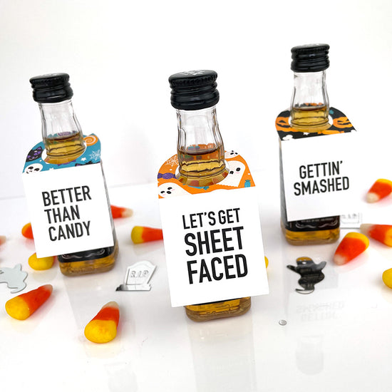 halloween miniature liquor bottle tags that read pumpkin punch, better than candy and bad and boozie