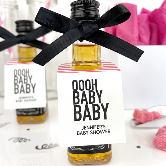 pink baby shower tags on mini liquor bottles