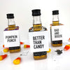 halloween mini liquor bottle tags that read pumpkin punch, better than candy and bad and boozie