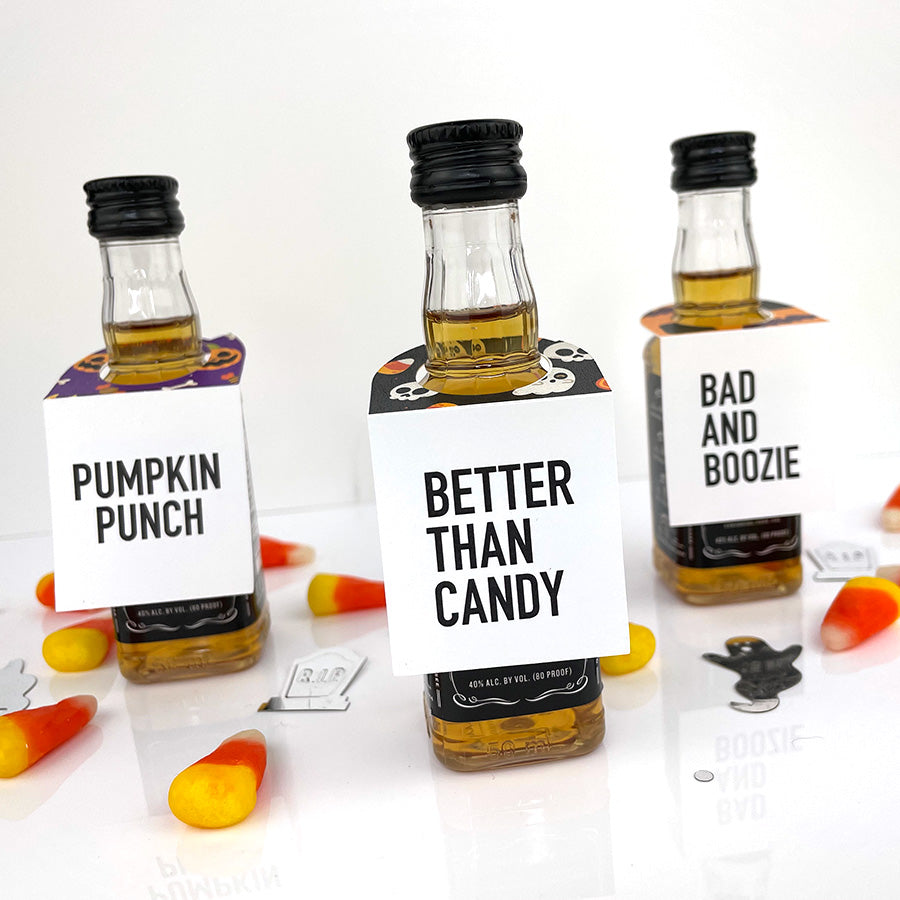 halloween mini liquor bottle tags that read pumpkin punch, better than candy and bad and boozie