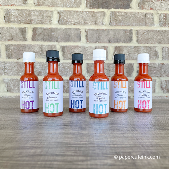 group of mini hot sauce birthday party favors on a table